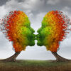 Aging couple relationship symbol and losing sex drive concept or low sexual desire metaphor as two trees shaped as kissing human heads losing leaves as in autumn season.